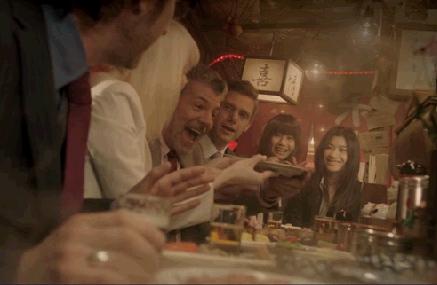 American businessman eating oden at Japanese yatai