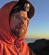 Self-portrait on the summit of Kengamine Peak. Note sun reflections on glasses & headlamp