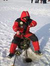 A gentleman ice fishing in Canada